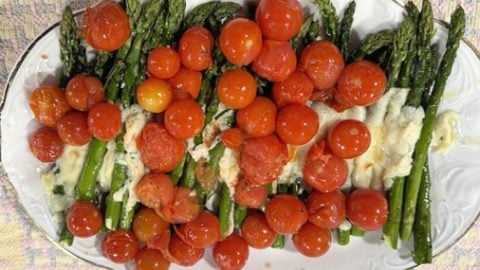This delicious recipe makes a perfect side dish for a Brunch Buffet. Roasted Asparagus smothered in Mozzarella Cheese before being topped with Roasted Cherry Tomatoes. Caprese has never tasted so good!