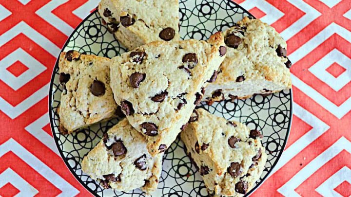 These scones are tender, buttery, and lightly sweetened. Each scone is golden on the outside with a soft, crumbly interior studded with rich chocolate chips.