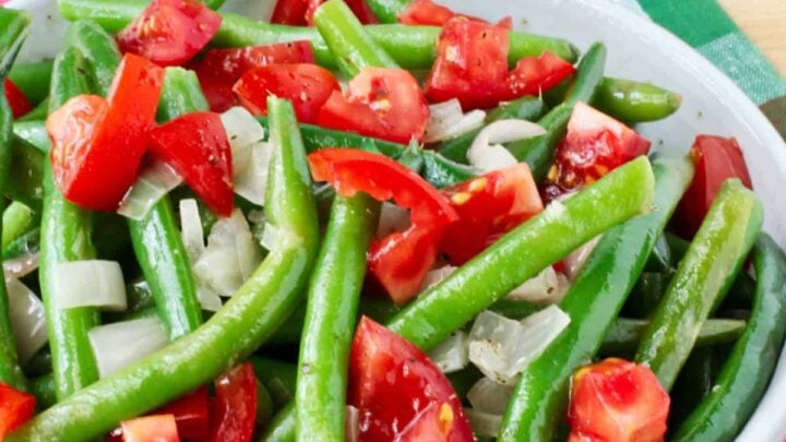 These green beans with shallots and tomatoes make a wonderful vegetable dish that you'll be tempted to eat with your fingers, kind of like French fries.