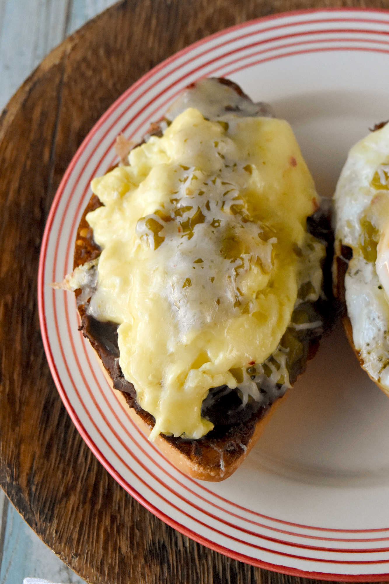 Experience the perfect blend of eggs and spicy green chiles in every bite of these mouthwatering molletes. Whether you're hosting a brunch or treating yourself on Mother's Day, this recipe is sure to impress. Don't wait any longer - unleash the flavor explosion today!
 
Looking for a new brunch favorite or a satisfying snack? Egg and green chile molletes are the answer! This simple yet delicious dish brings together warm bread, crispy eggs, and zesty green chiles for a meal that’s both comforting and exciting. Whether you’re a seasoned cook or just starting out, molletes are sure to become a staple in your kitchen.
 
What Are Molletes?
 
Molletes are a traditional Mexican open-faced sandwich.  They’re typically made by topping sliced bread with refried beans and cheese, then baking until golden and bubbly. Our version adds a flavorful twist by including crispy fried eggs topped with green chiles, enhancing both texture and taste. Molletes are loved for their versatility and ability to satisfy cravings any time of day.
 
P2V
 
This dish has roots in Mexican culinary traditions, dating back to colonial times when bread became a staple. Molletes were originally a way to use up leftover bread and beans, turning simple ingredients into a comforting meal. Over time, molletes have evolved, reflecting regional tastes and creative adaptations. Today, they’re enjoyed across Mexico and beyond, celebrated for their ease and flavor.
 
Basic Molletes Ingredients
 
To make egg and green chile molletes, you’ll need these essentials:
Bread (bolillo, baguette, or other crusty loaf)
Eggs
Green chiles (fresh or canned)
Refried beans
Cheese (such as Monterey Jack or queso fresco)
Butter or oil
Salt and pepper
 
P3H
 
Gather Your Ingredients
 
Choose a sturdy bread that holds up well to toppings. Bollilos are oval-shaped Mexican rolls with a crisp golden crust and a soft, airy interior, perfect for holding hearty toppings.  For green chiles, canned varieties work in a pinch, but fresh roasted chiles will add extra depth. Make sure your eggs are fresh and select a melty cheese for that signature gooey finish. I like a Colby or pepper jack.  Sometimes I opt for a quesadilla cheese which is super cheesy and delicious.  Prepping all ingredients beforehand makes assembly easy and stress-free.
 
Customizing Your Molletes
 
Molletes are wonderfully adaptable. Change up the cheese to one you like.  Melty and delicious like a cheddar or sprinkle some Oaxaca on top.  Level up the protein and add cooked sausage or bacon.  Finally, sprinkle the finished dish with fresh cilantro or sliced green onions for extra flavor. Up the veggies and add sautéed mushrooms or onions. Spice lovers can use hotter chiles or add a dash of hot sauce.
 
P4V
 
Type of Bread Used for Molletes
 
Bolillo rolls are the traditional choice.  They are known for their crisp crust and soft interior. If you can’t find bolillos, try using a baguette.  Or you can grab ciabatta loaf or roll.  You can even try sourdough or French bread.  I’ve made plenty of French bread pizzas and know it will stand up to all the toppings.  The key is finding bread that won’t get soggy and offers a sturdy base for your toppings.
 
Prep Your Bread
 
Slice your bread in half lengthwise and lightly toast it to help create a crunchy foundation. You can brush the cut sides with butter for added richness before toasting under the broiler or in a toaster oven.  If you’re toasting it in the broiler, make sure to keep an eye on it.  It will burn faster than you think.  I’m talking seconds.  So, don’t let it go unattended.
 
P5V
 
Cook the Eggs and Green Chiles
 
Cook your eggs in a skillet.  I made some crispy edged fried eggs.  I like mine well done.  But you can make them over easy or even sunny side up if you want.  Or you can scramble them.  If you opt for scrambled you can stir in the diced green chiles. 
 
If you’re going to scramble them, aim for soft, creamy eggs so they stay moist when assembled with the other ingredients.  Gently whisk your eggs and cook them over low heat.  Stir continuously to create small, creamy curds. Remove the eggs from the heat just before they’re fully set to ensure they stay tender and moist, perfect for topping molletes.
 
P6H
 
Assemble Your Molletes
 
Spread a generous layer of refried beans on each toasted bread half. There are several types to choose from.  I like black refried beans.  They’re rich and delicious.  But you can find pinto and Peruvian beans.  Or you can make your own out of any type of bean you want.  Top with the fried egg (or scrambled) and then some green chiles.  Next, sprinkle with cheese. Finally, return to the oven until the cheese melts and bubbles. Serve warm garnished with cilantro or sliced green onions and a dash of cholula sauce for an added kick.
 
For a Mother’s Day brunch, serve these molletes family-style on a big platter so everyone can grab a warm, melty piece. Have a toppings bar so they can finish their own with fresh toppings like sliced avocado, pico de gallo, cilantro, or a drizzle of your favorite hot sauce.
 
P7V
 
They pair beautifully with a bright fruit salad (think berries, melon, and citrus) or a simple green salad with a lime vinaigrette.  You can also serve them with some patatas bravas, or crispy and spicy breakfast potatoes to round out the meal. I’m fond a creamy, homemade guacamole to dallop on top.  For drinks, try serving it with an agua fresca or sparkling water with grapefruit and mint.  Or for a luscious libation a delicious michelada, mimosa or a paloma with grapefruit soda and tequila.  They add a festive touch and pair beautifully with the bold flavors of molletes.
 
Enjoy Your Flavorful Creation
 
Fried egg and green chile molletes are a vibrant Mexican-inspired breakfast dish, featuring crispy-edged fried eggs nestled atop toasted bread halves generously layered with rich refried beans. The eggs are topped with diced green chiles, adding a mild heat and zesty flavor that perfectly complements the creamy beans. Finished with a sprinkle of cheese and melted until bubbly, these molletes offer a satisfying combination of savory, spicy, and cheesy elements in every bite, making them an irresistible option for brunch or a special occasion.
 
P8H
 
If you’re looking to round out your Mother’s Day brunch spread with more Latin American flavors, consider serving sweet and savory treats.  Serve these with some Mexican chilaquiles consist of crispy tortilla chips simmered in salsa and topped with crema and queso fresco.   Or try these with some Argentinian medialunas, which are buttery crescent rolls that are perfect for pairing with coffee. Finally, Colombian arepas.  They are lightly grilled and filled with cheese or eggs, making them a delightful addition alongside molletes.
 
You could also add Brazilian pão de queijo.  They’re soft and chewy cheese breads that re addictive!  Or try a Peruvian fruit salad with passion fruit and mango for a refreshing touch.  These molletes would be perfect paired with sweet or savory empanadas, too.