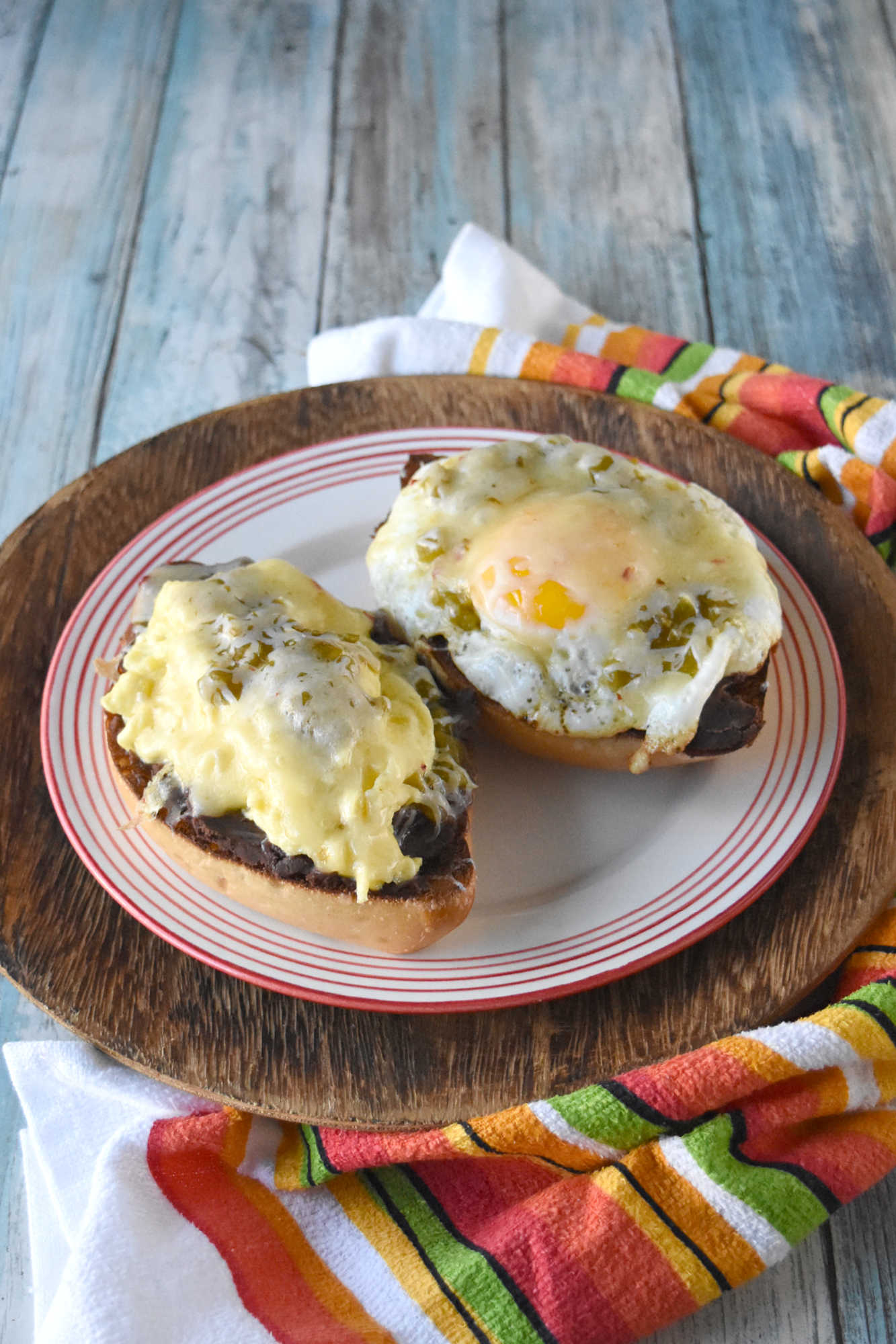 Experience the perfect blend of eggs and spicy green chiles in every bite of these mouthwatering molletes. Whether you're hosting a brunch or treating yourself on Mother's Day, this recipe is sure to impress. Don't wait any longer - unleash the flavor explosion today!
 
Looking for a new brunch favorite or a satisfying snack? Egg and green chile molletes are the answer! This simple yet delicious dish brings together warm bread, crispy eggs, and zesty green chiles for a meal that’s both comforting and exciting. Whether you’re a seasoned cook or just starting out, molletes are sure to become a staple in your kitchen.
 
What Are Molletes?
 
Molletes are a traditional Mexican open-faced sandwich.  They’re typically made by topping sliced bread with refried beans and cheese, then baking until golden and bubbly. Our version adds a flavorful twist by including crispy fried eggs topped with green chiles, enhancing both texture and taste. Molletes are loved for their versatility and ability to satisfy cravings any time of day.
 
P2V
 
This dish has roots in Mexican culinary traditions, dating back to colonial times when bread became a staple. Molletes were originally a way to use up leftover bread and beans, turning simple ingredients into a comforting meal. Over time, molletes have evolved, reflecting regional tastes and creative adaptations. Today, they’re enjoyed across Mexico and beyond, celebrated for their ease and flavor.
 
Basic Molletes Ingredients
 
To make egg and green chile molletes, you’ll need these essentials:
Bread (bolillo, baguette, or other crusty loaf)
Eggs
Green chiles (fresh or canned)
Refried beans
Cheese (such as Monterey Jack or queso fresco)
Butter or oil
Salt and pepper
 
P3H
 
Gather Your Ingredients
 
Choose a sturdy bread that holds up well to toppings. Bollilos are oval-shaped Mexican rolls with a crisp golden crust and a soft, airy interior, perfect for holding hearty toppings.  For green chiles, canned varieties work in a pinch, but fresh roasted chiles will add extra depth. Make sure your eggs are fresh and select a melty cheese for that signature gooey finish. I like a Colby or pepper jack.  Sometimes I opt for a quesadilla cheese which is super cheesy and delicious.  Prepping all ingredients beforehand makes assembly easy and stress-free.
 
Customizing Your Molletes
 
Molletes are wonderfully adaptable. Change up the cheese to one you like.  Melty and delicious like a cheddar or sprinkle some Oaxaca on top.  Level up the protein and add cooked sausage or bacon.  Finally, sprinkle the finished dish with fresh cilantro or sliced green onions for extra flavor. Up the veggies and add sautéed mushrooms or onions. Spice lovers can use hotter chiles or add a dash of hot sauce.
 
P4V
 
Type of Bread Used for Molletes
 
Bolillo rolls are the traditional choice.  They are known for their crisp crust and soft interior. If you can’t find bolillos, try using a baguette.  Or you can grab ciabatta loaf or roll.  You can even try sourdough or French bread.  I’ve made plenty of French bread pizzas and know it will stand up to all the toppings.  The key is finding bread that won’t get soggy and offers a sturdy base for your toppings.
 
Prep Your Bread
 
Slice your bread in half lengthwise and lightly toast it to help create a crunchy foundation. You can brush the cut sides with butter for added richness before toasting under the broiler or in a toaster oven.  If you’re toasting it in the broiler, make sure to keep an eye on it.  It will burn faster than you think.  I’m talking seconds.  So, don’t let it go unattended.
 
P5V
 
Cook the Eggs and Green Chiles
 
Cook your eggs in a skillet.  I made some crispy edged fried eggs.  I like mine well done.  But you can make them over easy or even sunny side up if you want.  Or you can scramble them.  If you opt for scrambled you can stir in the diced green chiles. 
 
If you’re going to scramble them, aim for soft, creamy eggs so they stay moist when assembled with the other ingredients.  Gently whisk your eggs and cook them over low heat.  Stir continuously to create small, creamy curds. Remove the eggs from the heat just before they’re fully set to ensure they stay tender and moist, perfect for topping molletes.
 
P6H
 
Assemble Your Molletes
 
Spread a generous layer of refried beans on each toasted bread half. There are several types to choose from.  I like black refried beans.  They’re rich and delicious.  But you can find pinto and Peruvian beans.  Or you can make your own out of any type of bean you want.  Top with the fried egg (or scrambled) and then some green chiles.  Next, sprinkle with cheese. Finally, return to the oven until the cheese melts and bubbles. Serve warm garnished with cilantro or sliced green onions and a dash of cholula sauce for an added kick.
 
For a Mother’s Day brunch, serve these molletes family-style on a big platter so everyone can grab a warm, melty piece. Have a toppings bar so they can finish their own with fresh toppings like sliced avocado, pico de gallo, cilantro, or a drizzle of your favorite hot sauce.
 
P7V
 
They pair beautifully with a bright fruit salad (think berries, melon, and citrus) or a simple green salad with a lime vinaigrette.  You can also serve them with some patatas bravas, or crispy and spicy breakfast potatoes to round out the meal. I’m fond a creamy, homemade guacamole to dallop on top.  For drinks, try serving it with an agua fresca or sparkling water with grapefruit and mint.  Or for a luscious libation a delicious michelada, mimosa or a paloma with grapefruit soda and tequila.  They add a festive touch and pair beautifully with the bold flavors of molletes.
 
Enjoy Your Flavorful Creation
 
Fried egg and green chile molletes are a vibrant Mexican-inspired breakfast dish, featuring crispy-edged fried eggs nestled atop toasted bread halves generously layered with rich refried beans. The eggs are topped with diced green chiles, adding a mild heat and zesty flavor that perfectly complements the creamy beans. Finished with a sprinkle of cheese and melted until bubbly, these molletes offer a satisfying combination of savory, spicy, and cheesy elements in every bite, making them an irresistible option for brunch or a special occasion.
 
P8H
 
If you’re looking to round out your Mother’s Day brunch spread with more Latin American flavors, consider serving sweet and savory treats.  Serve these with some Mexican chilaquiles consist of crispy tortilla chips simmered in salsa and topped with crema and queso fresco.   Or try these with some Argentinian medialunas, which are buttery crescent rolls that are perfect for pairing with coffee. Finally, Colombian arepas.  They are lightly grilled and filled with cheese or eggs, making them a delightful addition alongside molletes.
 
You could also add Brazilian pão de queijo.  They’re soft and chewy cheese breads that re addictive!  Or try a Peruvian fruit salad with passion fruit and mango for a refreshing touch.  These molletes would be perfect paired with sweet or savory empanadas, too.