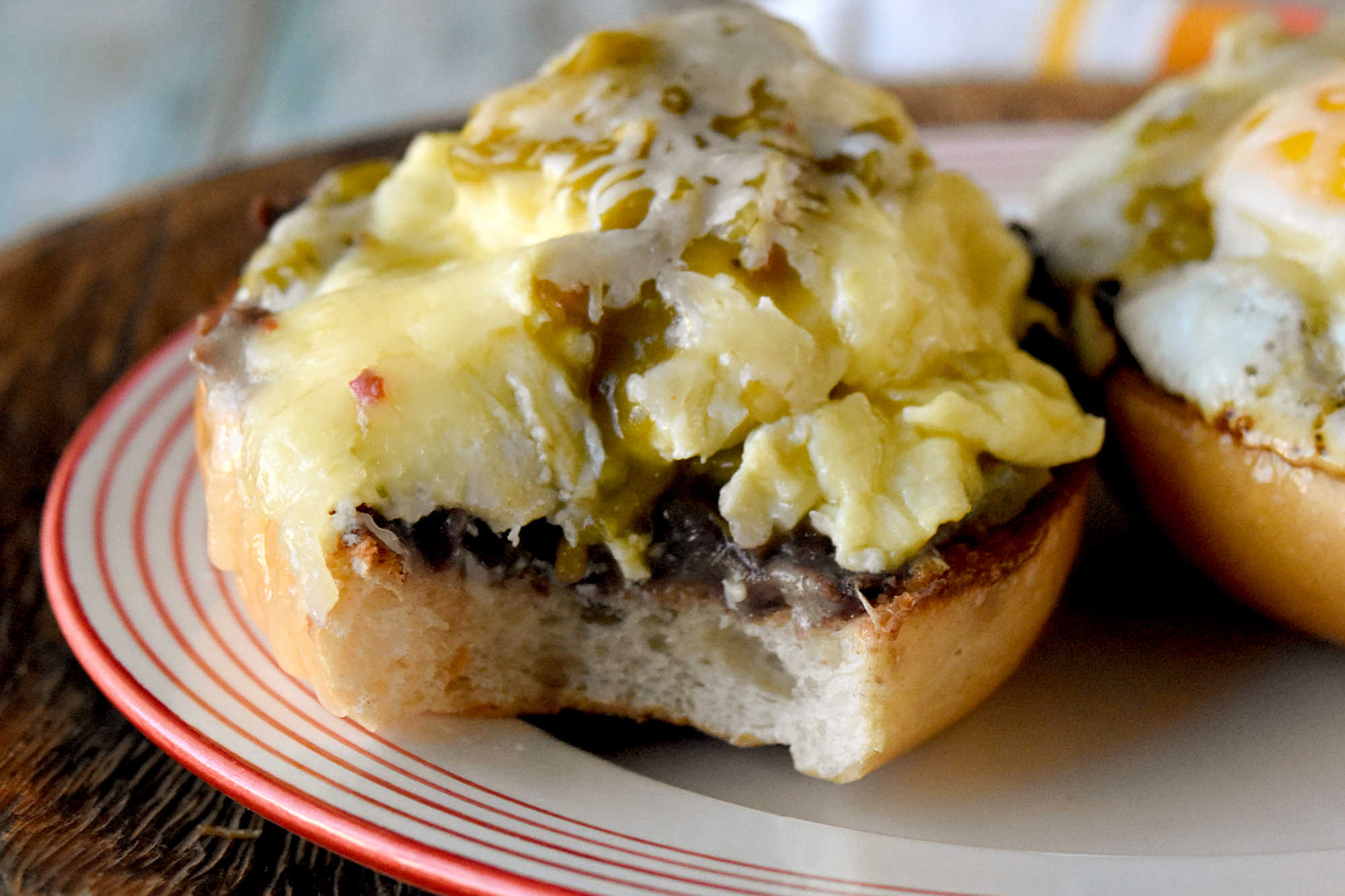 Experience the perfect blend of eggs and spicy green chiles in every bite of these mouthwatering molletes. Whether you're hosting a brunch or treating yourself on Mother's Day, this recipe is sure to impress. Don't wait any longer - unleash the flavor explosion today!   Looking for a new brunch favorite or a satisfying snack? Egg and green chile molletes are the answer! This simple yet delicious dish brings together warm bread, crispy eggs, and zesty green chiles for a meal that’s both comforting and exciting. Whether you’re a seasoned cook or just starting out, molletes are sure to become a staple in your kitchen.   What Are Molletes?   Molletes are a traditional Mexican open-faced sandwich.  They’re typically made by topping sliced bread with refried beans and cheese, then baking until golden and bubbly. Our version adds a flavorful twist by including crispy fried eggs topped with green chiles, enhancing both texture and taste. Molletes are loved for their versatility and ability to satisfy cravings any time of day.   P2V   This dish has roots in Mexican culinary traditions, dating back to colonial times when bread became a staple. Molletes were originally a way to use up leftover bread and beans, turning simple ingredients into a comforting meal. Over time, molletes have evolved, reflecting regional tastes and creative adaptations. Today, they’re enjoyed across Mexico and beyond, celebrated for their ease and flavor.   Basic Molletes Ingredients   To make egg and green chile molletes, you’ll need these essentials: Bread (bolillo, baguette, or other crusty loaf) Eggs Green chiles (fresh or canned) Refried beans Cheese (such as Monterey Jack or queso fresco) Butter or oil Salt and pepper   P3H   Gather Your Ingredients   Choose a sturdy bread that holds up well to toppings. Bollilos are oval-shaped Mexican rolls with a crisp golden crust and a soft, airy interior, perfect for holding hearty toppings.  For green chiles, canned varieties work in a pinch, but fresh roasted chiles will add extra depth. Make sure your eggs are fresh and select a melty cheese for that signature gooey finish. I like a Colby or pepper jack.  Sometimes I opt for a quesadilla cheese which is super cheesy and delicious.  Prepping all ingredients beforehand makes assembly easy and stress-free.   Customizing Your Molletes   Molletes are wonderfully adaptable. Change up the cheese to one you like.  Melty and delicious like a cheddar or sprinkle some Oaxaca on top.  Level up the protein and add cooked sausage or bacon.  Finally, sprinkle the finished dish with fresh cilantro or sliced green onions for extra flavor. Up the veggies and add sautéed mushrooms or onions. Spice lovers can use hotter chiles or add a dash of hot sauce.   P4V   Type of Bread Used for Molletes   Bolillo rolls are the traditional choice.  They are known for their crisp crust and soft interior. If you can’t find bolillos, try using a baguette.  Or you can grab ciabatta loaf or roll.  You can even try sourdough or French bread.  I’ve made plenty of French bread pizzas and know it will stand up to all the toppings.  The key is finding bread that won’t get soggy and offers a sturdy base for your toppings.   Prep Your Bread   Slice your bread in half lengthwise and lightly toast it to help create a crunchy foundation. You can brush the cut sides with butter for added richness before toasting under the broiler or in a toaster oven.  If you’re toasting it in the broiler, make sure to keep an eye on it.  It will burn faster than you think.  I’m talking seconds.  So, don’t let it go unattended.   P5V   Cook the Eggs and Green Chiles   Cook your eggs in a skillet.  I made some crispy edged fried eggs.  I like mine well done.  But you can make them over easy or even sunny side up if you want.  Or you can scramble them.  If you opt for scrambled you can stir in the diced green chiles.    If you’re going to scramble them, aim for soft, creamy eggs so they stay moist when assembled with the other ingredients.  Gently whisk your eggs and cook them over low heat.  Stir continuously to create small, creamy curds. Remove the eggs from the heat just before they’re fully set to ensure they stay tender and moist, perfect for topping molletes.   P6H   Assemble Your Molletes   Spread a generous layer of refried beans on each toasted bread half. There are several types to choose from.  I like black refried beans.  They’re rich and delicious.  But you can find pinto and Peruvian beans.  Or you can make your own out of any type of bean you want.  Top with the fried egg (or scrambled) and then some green chiles.  Next, sprinkle with cheese. Finally, return to the oven until the cheese melts and bubbles. Serve warm garnished with cilantro or sliced green onions and a dash of cholula sauce for an added kick.   For a Mother’s Day brunch, serve these molletes family-style on a big platter so everyone can grab a warm, melty piece. Have a toppings bar so they can finish their own with fresh toppings like sliced avocado, pico de gallo, cilantro, or a drizzle of your favorite hot sauce.   P7V   They pair beautifully with a bright fruit salad (think berries, melon, and citrus) or a simple green salad with a lime vinaigrette.  You can also serve them with some patatas bravas, or crispy and spicy breakfast potatoes to round out the meal. I’m fond a creamy, homemade guacamole to dallop on top.  For drinks, try serving it with an agua fresca or sparkling water with grapefruit and mint.  Or for a luscious libation a delicious michelada, mimosa or a paloma with grapefruit soda and tequila.  They add a festive touch and pair beautifully with the bold flavors of molletes.   Enjoy Your Flavorful Creation   Fried egg and green chile molletes are a vibrant Mexican-inspired breakfast dish, featuring crispy-edged fried eggs nestled atop toasted bread halves generously layered with rich refried beans. The eggs are topped with diced green chiles, adding a mild heat and zesty flavor that perfectly complements the creamy beans. Finished with a sprinkle of cheese and melted until bubbly, these molletes offer a satisfying combination of savory, spicy, and cheesy elements in every bite, making them an irresistible option for brunch or a special occasion.   P8H   If you’re looking to round out your Mother’s Day brunch spread with more Latin American flavors, consider serving sweet and savory treats.  Serve these with some Mexican chilaquiles consist of crispy tortilla chips simmered in salsa and topped with crema and queso fresco.   Or try these with some Argentinian medialunas, which are buttery crescent rolls that are perfect for pairing with coffee. Finally, Colombian arepas.  They are lightly grilled and filled with cheese or eggs, making them a delightful addition alongside molletes.   You could also add Brazilian pão de queijo.  They’re soft and chewy cheese breads that re addictive!  Or try a Peruvian fruit salad with passion fruit and mango for a refreshing touch.  These molletes would be perfect paired with sweet or savory empanadas, too.