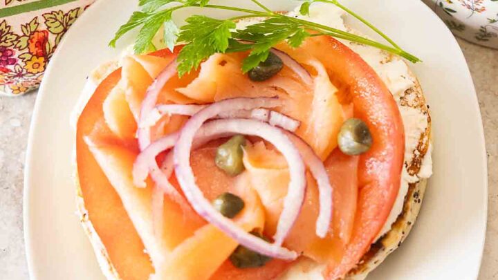 Bagels & Lox pairs cured salmon, rich cream cheese, juicy tomatoes, & onion, with bagels for a simple but special brunch or breakfast dish.