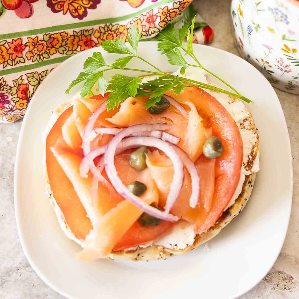 Bagels & Lox pairs cured salmon, rich cream cheese, juicy tomatoes, & onion, with bagels for a simple but special brunch or breakfast dish.