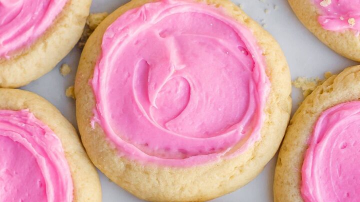 This Copycat Crumbl Sugar Cookie Recipe is the best-tasting frosted sugar cookie! Thick, buttery, soft, and sweetened with an almond frosting. You can now make your own Crumbl cookies at home!