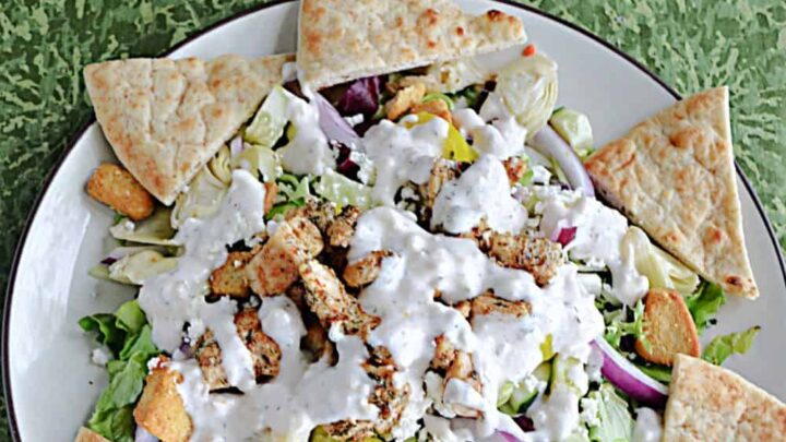 Enjoy a hearty Greek Chicken Salad with Creamy Dressing served with a side of pita bread for a filling and flavorful entree salad idea.