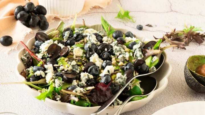 Fresh blueberry grape salad with avocado, greens, seeds, blue cheese, and homemade balsamic glaze. A light, colorful salad ready in about 30 minutes.