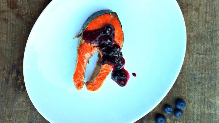 Smoky cedar plank grilled sockeye salmon topped with sweet maple blueberry chutney makes an easy and flavorful summer dinner recipe perfect for grilling season.