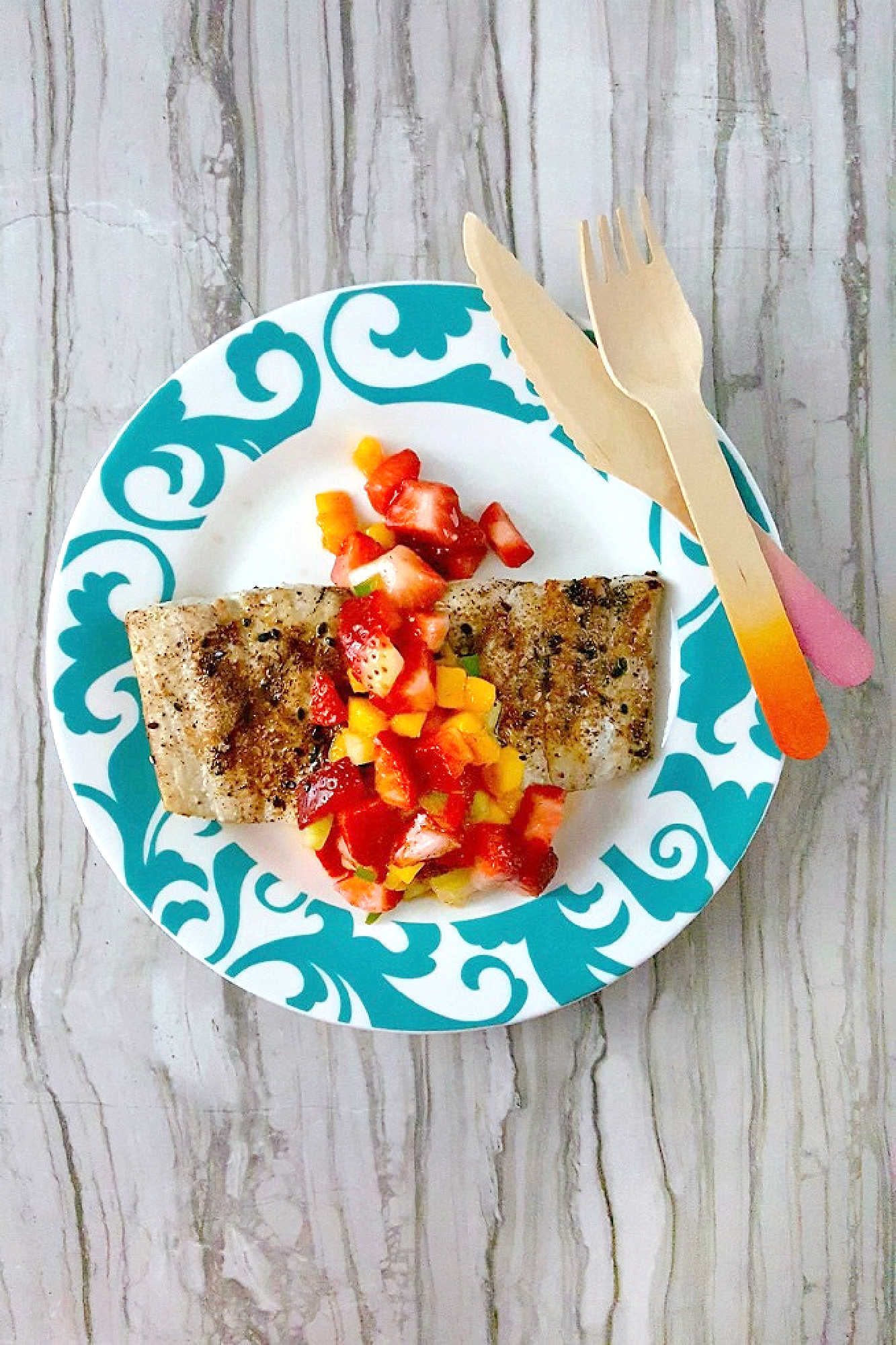 Savor the perfect blend of freshness and flavor with grilled fish topped with strawberry salsa. Dinner al fresco just found its new favorite. #OurFamilyTable #SeafoodLovers #HealthyEating #TastyTreat #GrilledFish #StrawberrySalsa #SummerGrilling #SeafoodLovers #StrawberrySalsa #FishRecipes