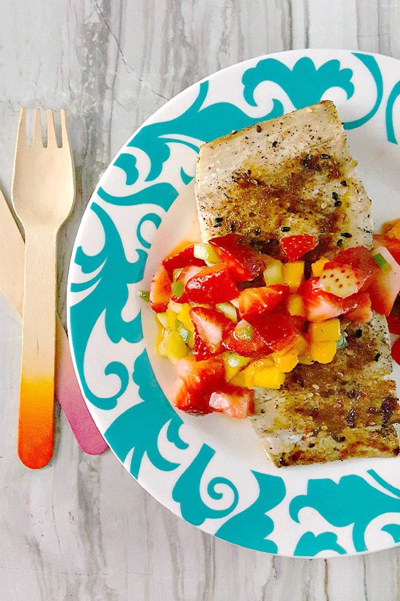 Savor the perfect blend of freshness and flavor with grilled fish topped with strawberry salsa. Dinner al fresco just found its new favorite. #OurFamilyTable #SeafoodLovers #HealthyEating #TastyTreat #GrilledFish #StrawberrySalsa #SummerGrilling #SeafoodLovers #StrawberrySalsa #FishRecipes
