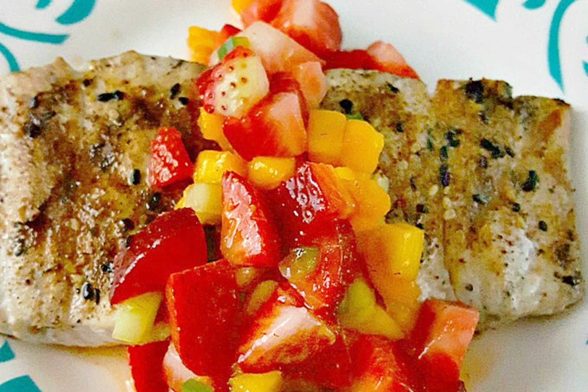 Savor the perfect blend of freshness and flavor with grilled fish topped with strawberry salsa. Dinner al fresco just found its new favorite. #OurFamilyTable #SeafoodLovers #HealthyEating #TastyTreat #GrilledFish #StrawberrySalsa #SummerGrilling #SeafoodLovers #StrawberrySalsa #FishRecipes