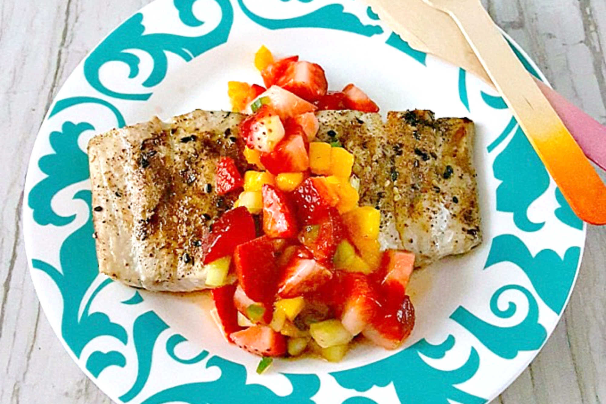 Savor the perfect blend of freshness and flavor with grilled fish topped with strawberry salsa. Dinner al fresco just found its new favorite. #OurFamilyTable #SeafoodLovers #HealthyEating #TastyTreat #GrilledFish #StrawberrySalsa #SummerGrilling #SeafoodLovers #StrawberrySalsa #FishRecipes