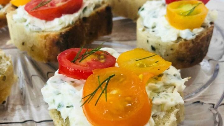 Open-Faced Tomato Sandwiches are served on artisan bread with a creamy cucumber and fresh herb spread for the perfect bite of summer flavors.