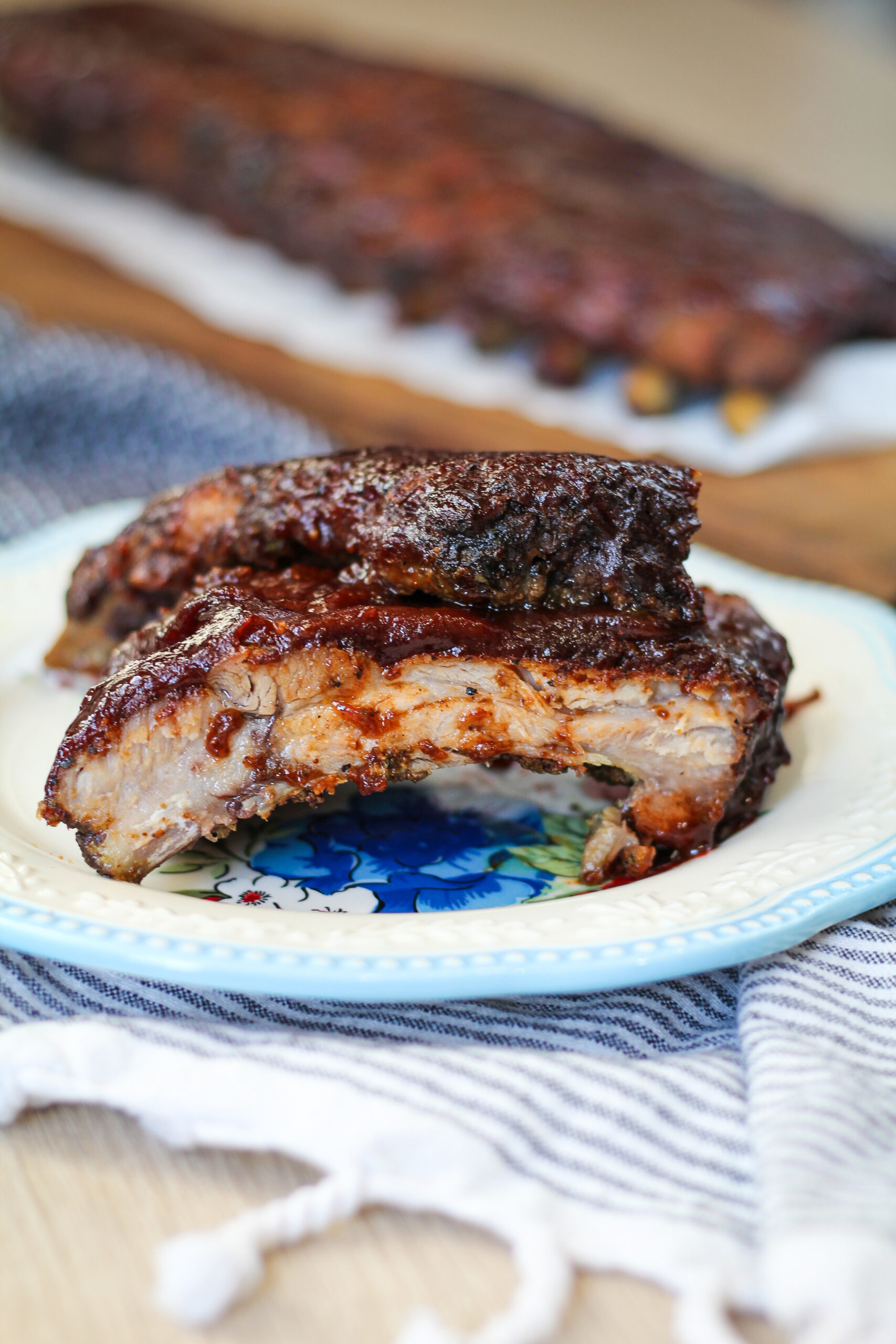 Slow roasted fall off the bone oven baked bbq ribs are the perfect addition to your weeknight meal. No-fuss dinners like this are my fave!