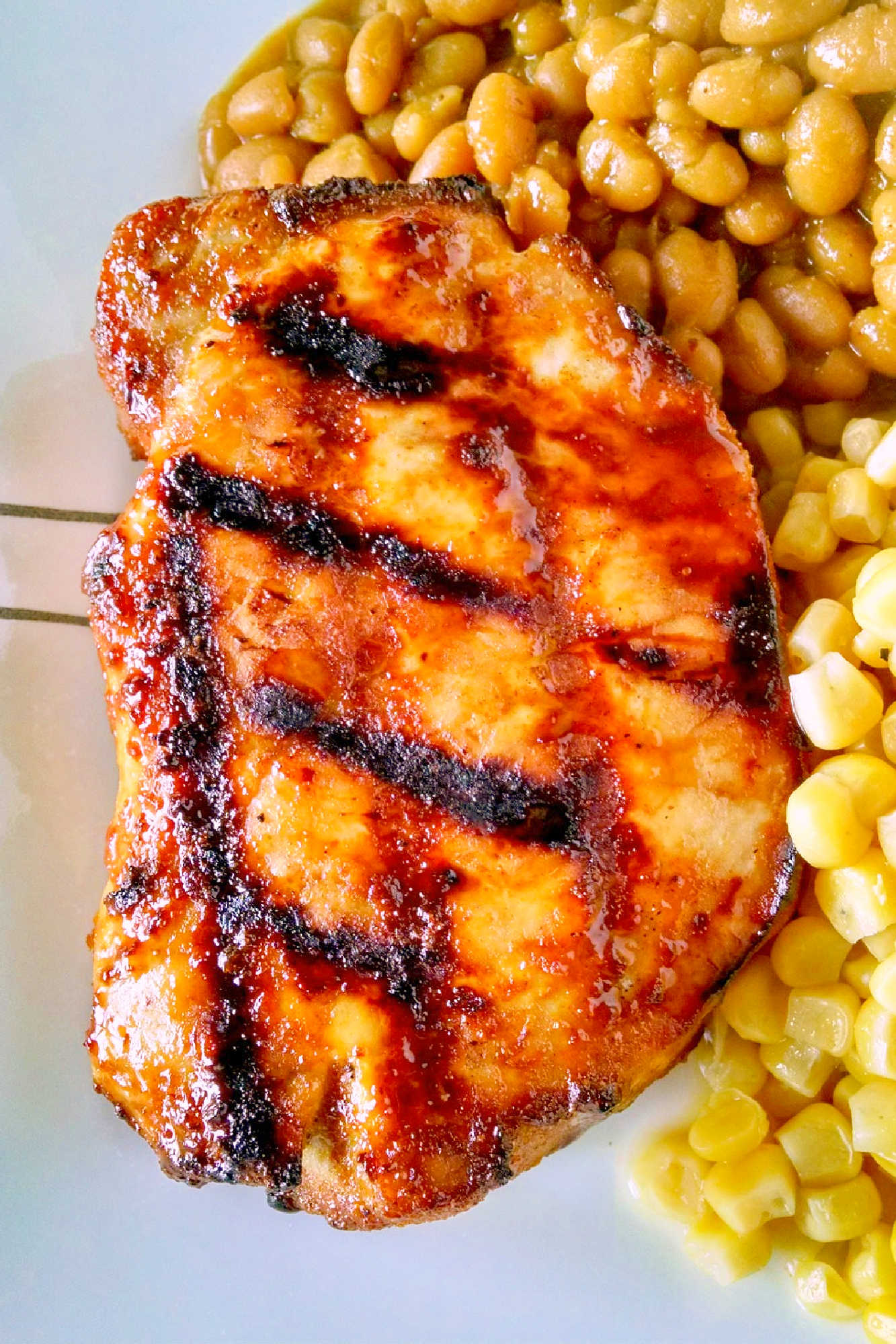 A twist on traditional barbecue sauce, this one replaces the tomato products with mustard. It’s spicy, vinegar-y kick is perfect with the sweet molasses. Mustard Barbecue Chops is our new fave summer meal! #getgrilling #porkchop #grilledchop #mustardsauce #barbecuesauce #MustardBBQChops #FlavorfulChops #SauceUpYourChops #PorkPerfection