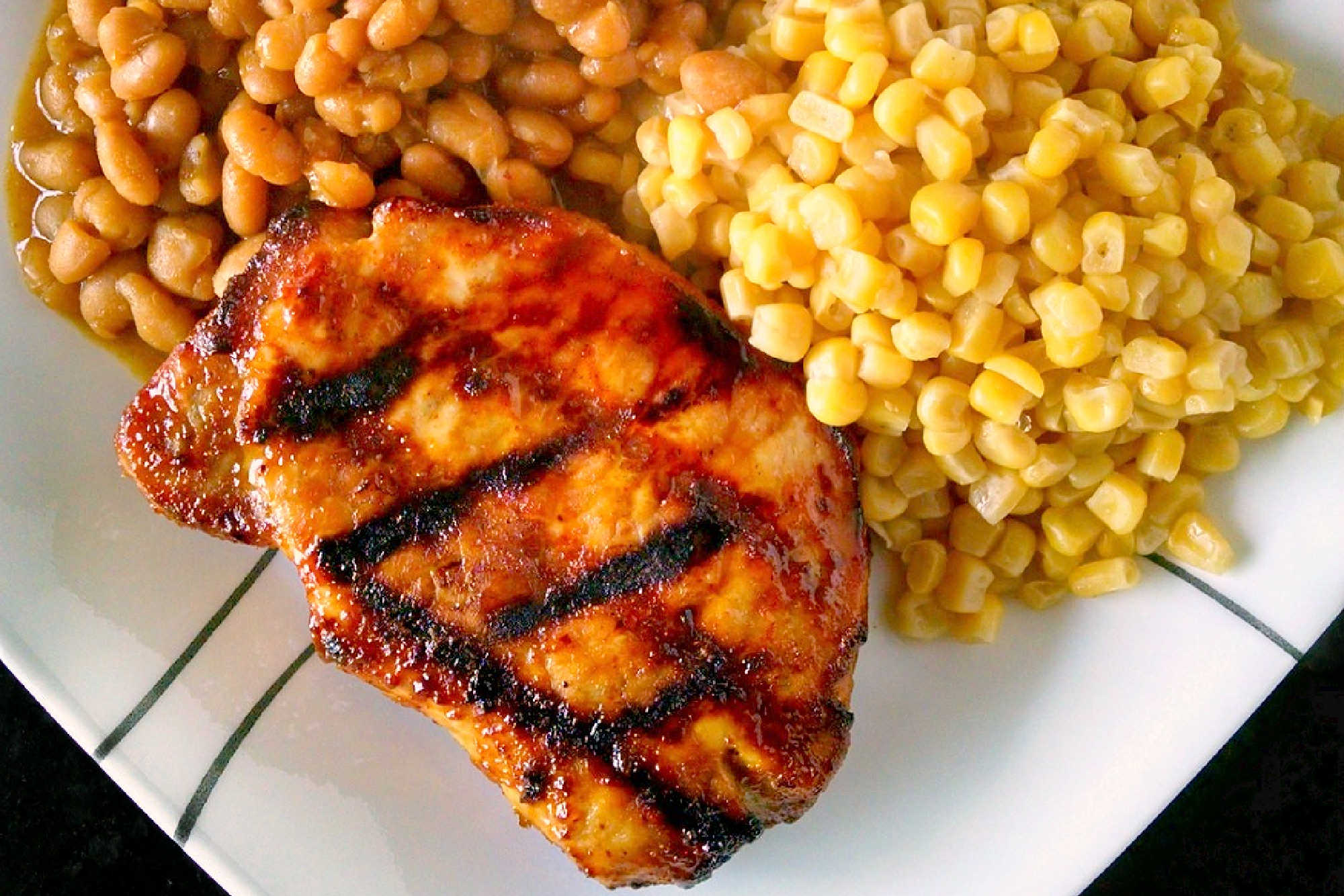 A twist on traditional barbecue sauce, this one replaces the tomato products with mustard. It’s spicy, vinegar-y kick is perfect with the sweet molasses. Mustard Barbecue Chops is our new fave summer meal! #getgrilling #porkchop #grilledchop #mustardsauce #barbecuesauce #MustardBBQChops #FlavorfulChops #SauceUpYourChops #PorkPerfection