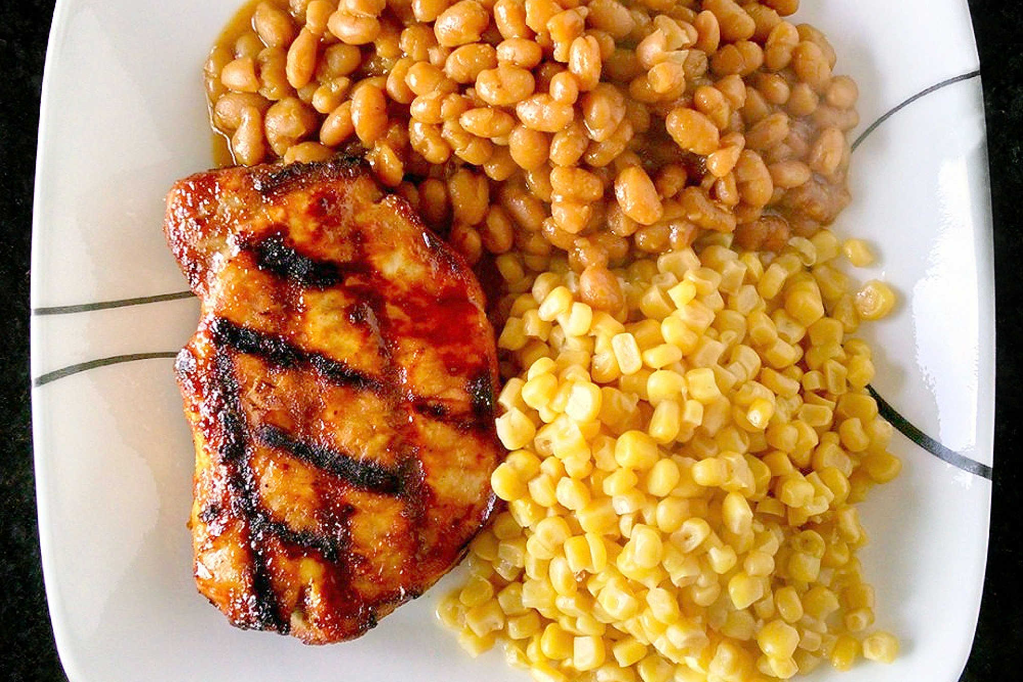 A twist on traditional barbecue sauce, this one replaces the tomato products with mustard. It’s spicy, vinegar-y kick is perfect with the sweet molasses. Mustard Barbecue Chops is our new fave summer meal! #getgrilling #porkchop #grilledchop #mustardsauce #barbecuesauce #MustardBBQChops #FlavorfulChops #SauceUpYourChops #PorkPerfection