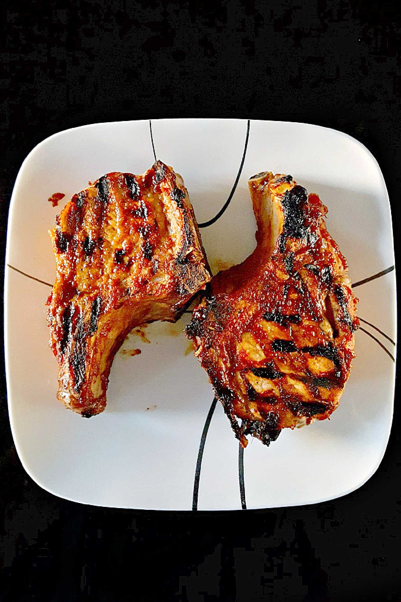 Savor the sweet and smoky harmony of pineapple barbeque chops paired with creamy colada slaw made with coconut chips and macadamia nuts. This dish brings people together and turns any meal into a mini celebration. #bbq #porkchop #pineapplesauce #pineapplebarbecue #PineappleBarbequeChops #ColadaSlaw #BBQlovers #SummerGrilling #TropicalFlavors