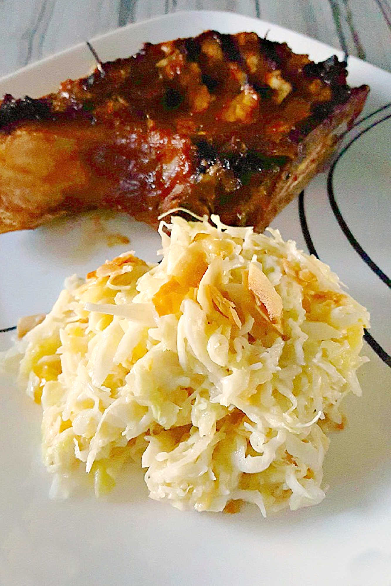 Savor the sweet and smoky harmony of pineapple barbeque chops paired with creamy colada slaw made with coconut chips and macadamia nuts. This dish brings people together and turns any meal into a mini celebration. #bbq #porkchop #pineapplesauce #pineapplebarbecue #PineappleBarbequeChops #ColadaSlaw #BBQlovers #SummerGrilling #TropicalFlavors