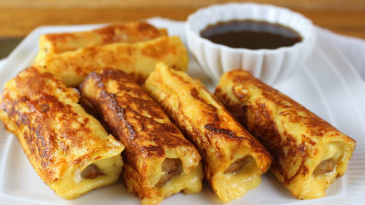 Sausage and Cheese French Toast Roll-Ups make a delicious hand held breakfast with meat, cheese and a maple syrup dip.