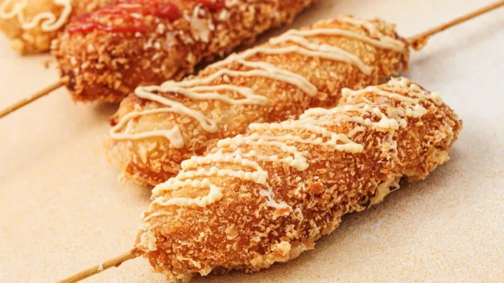 Make crispy, cheesy Korean corn dogs at home with this easy street food recipe! Hot dogs and cheese are dipped in batter, rolled in panko, and fried to golden perfection.