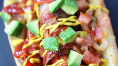 L.A. Style Danger Dogs - bacon-wrapped grilled hot dogs topped with mustard, ketchup, mayo, grilled onions and peppers, fresh pico de gallo, and often topped with a grilled jalapeño pepper.