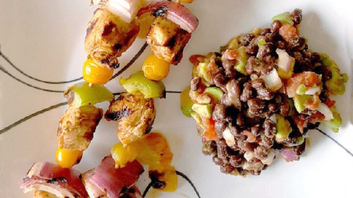 Fire up the grill for Chicken Fajita Kabobs loaded with juicy chicken, sweet peppers, onions, and bursty cherry tomatoes. Serve the smoky skewers with black bean and avocado salsa for a fresh, creamy, colorful Tex-Mex dinner that’s cookout ready and family approved. #ChickenFajitaKabobs #EasyGrillingRecipes #SummerDinner #ChickenKabobs #TexMexRecipes #AvocadoSalsa #FamilyMeals #OurFamilyTable
