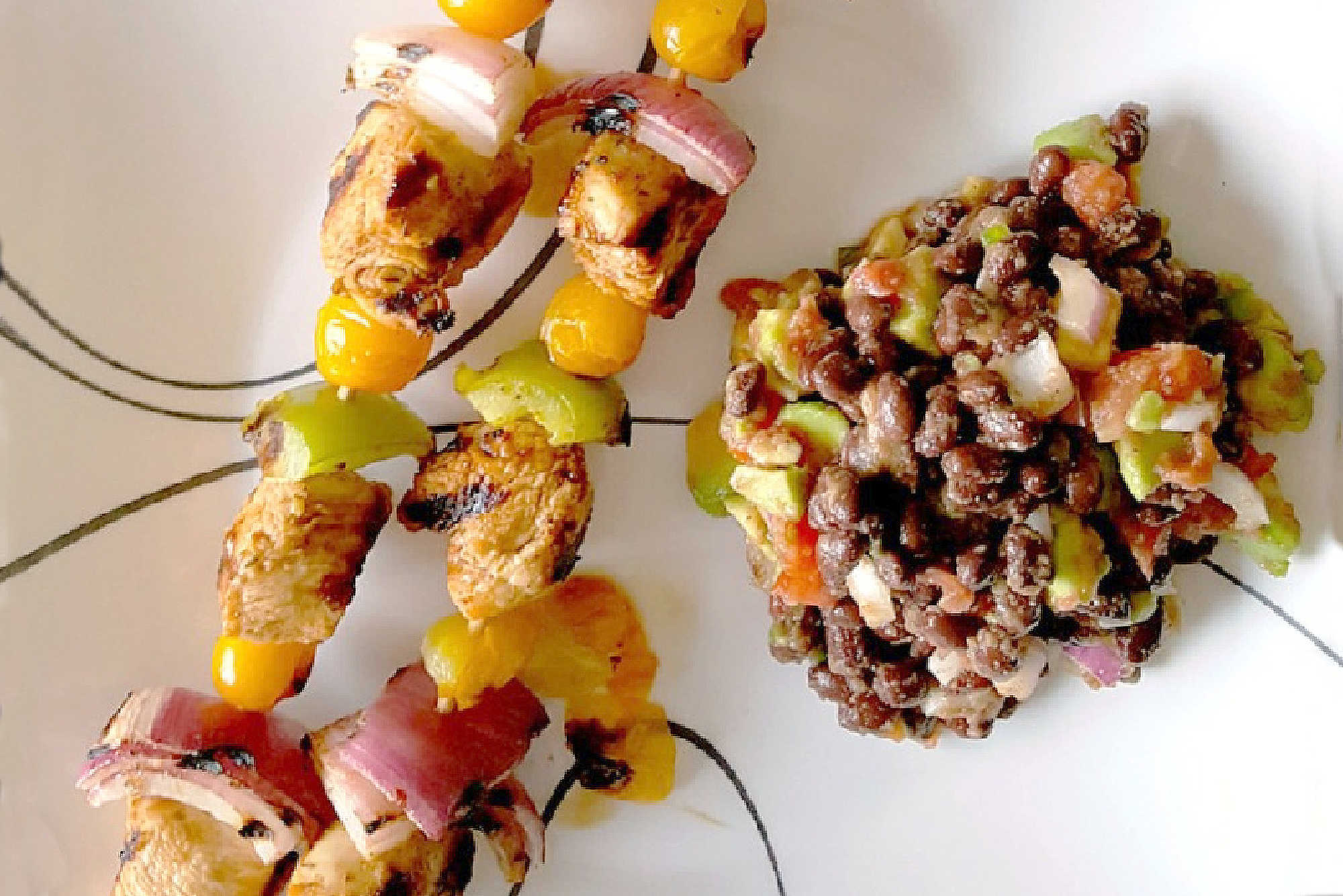 Fire up the grill for Chicken Fajita Kabobs loaded with juicy chicken, sweet peppers, onions, and bursty cherry tomatoes. Serve the smoky skewers with black bean and avocado salsa for a fresh, creamy, colorful Tex-Mex dinner that’s cookout ready and family approved. #ChickenFajitaKabobs #EasyGrillingRecipes #SummerDinner #ChickenKabobs #TexMexRecipes #AvocadoSalsa #FamilyMeals #OurFamilyTable