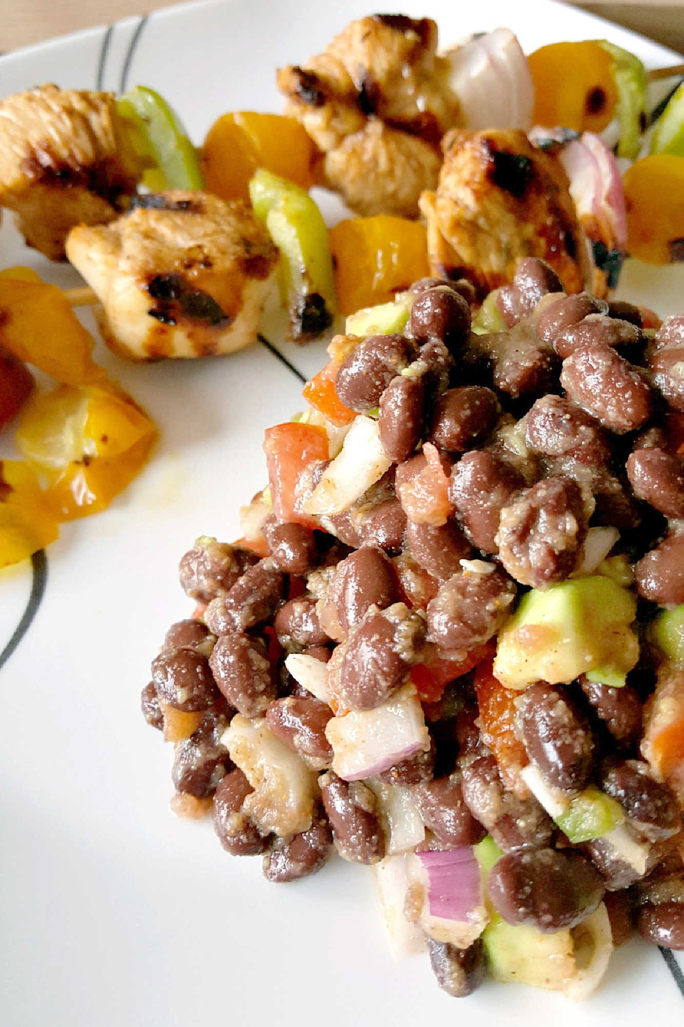 Fire up the grill for Chicken Fajita Kabobs loaded with juicy chicken, sweet peppers, onions, and bursty cherry tomatoes. Serve the smoky skewers with black bean and avocado salsa for a fresh, creamy, colorful Tex-Mex dinner that’s cookout ready and family approved. #ChickenFajitaKabobs #EasyGrillingRecipes #SummerDinner #ChickenKabobs #TexMexRecipes #AvocadoSalsa #FamilyMeals #OurFamilyTable