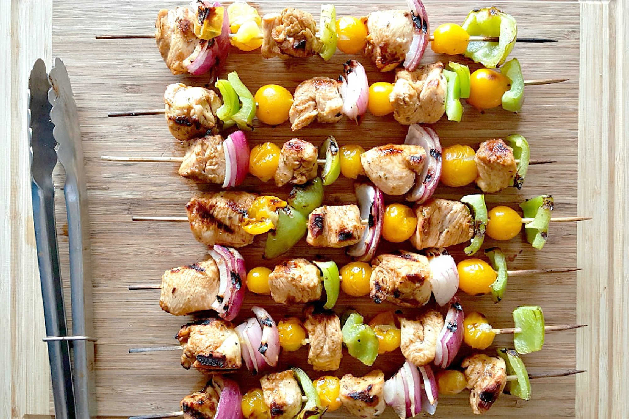 Fire up the grill for Chicken Fajita Kabobs loaded with juicy chicken, sweet peppers, onions, and bursty cherry tomatoes. Serve the smoky skewers with black bean and avocado salsa for a fresh, creamy, colorful Tex-Mex dinner that’s cookout ready and family approved. #ChickenFajitaKabobs #EasyGrillingRecipes #SummerDinner #ChickenKabobs #TexMexRecipes #AvocadoSalsa #FamilyMeals #OurFamilyTable