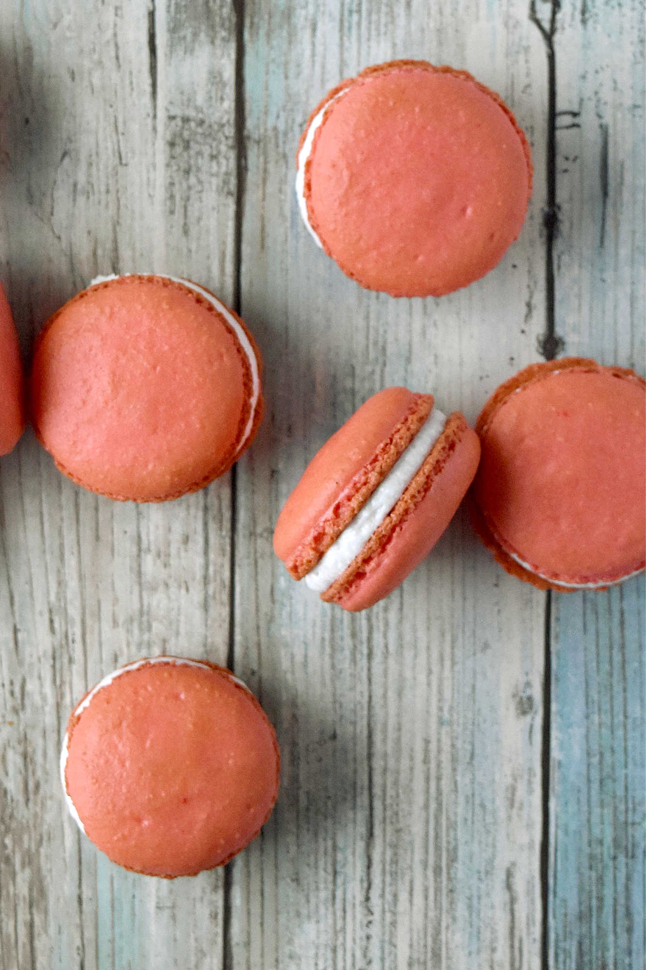 Peach macarons are the sweetest little summer bake. These use freeze-dried peaches in the shells and peach syrup in the filling for bright, fruity flavor in every bite. Perfect for a beginner-friendly showstopper! #peachmacarons #macarons #frenchmacarons #macaronlove #peachdessert #summerdesserts #prettybakes #bakingfromscratch #homebaker #desserttable #teapartyideas #bridalshowerdesserts #Stonefruit
