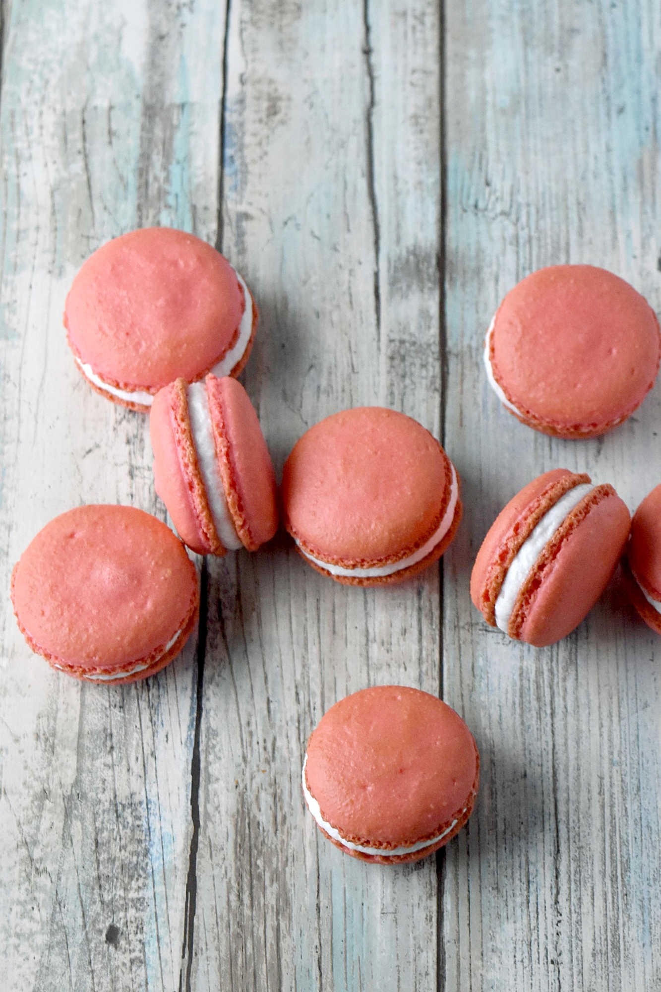 Peach macarons are the sweetest little summer bake. These use freeze-dried peaches in the shells and peach syrup in the filling for bright, fruity flavor in every bite. Perfect for a beginner-friendly showstopper! #peachmacarons #macarons #frenchmacarons #macaronlove #peachdessert #summerdesserts #prettybakes #bakingfromscratch #homebaker #desserttable #teapartyideas #bridalshowerdesserts #Stonefruit