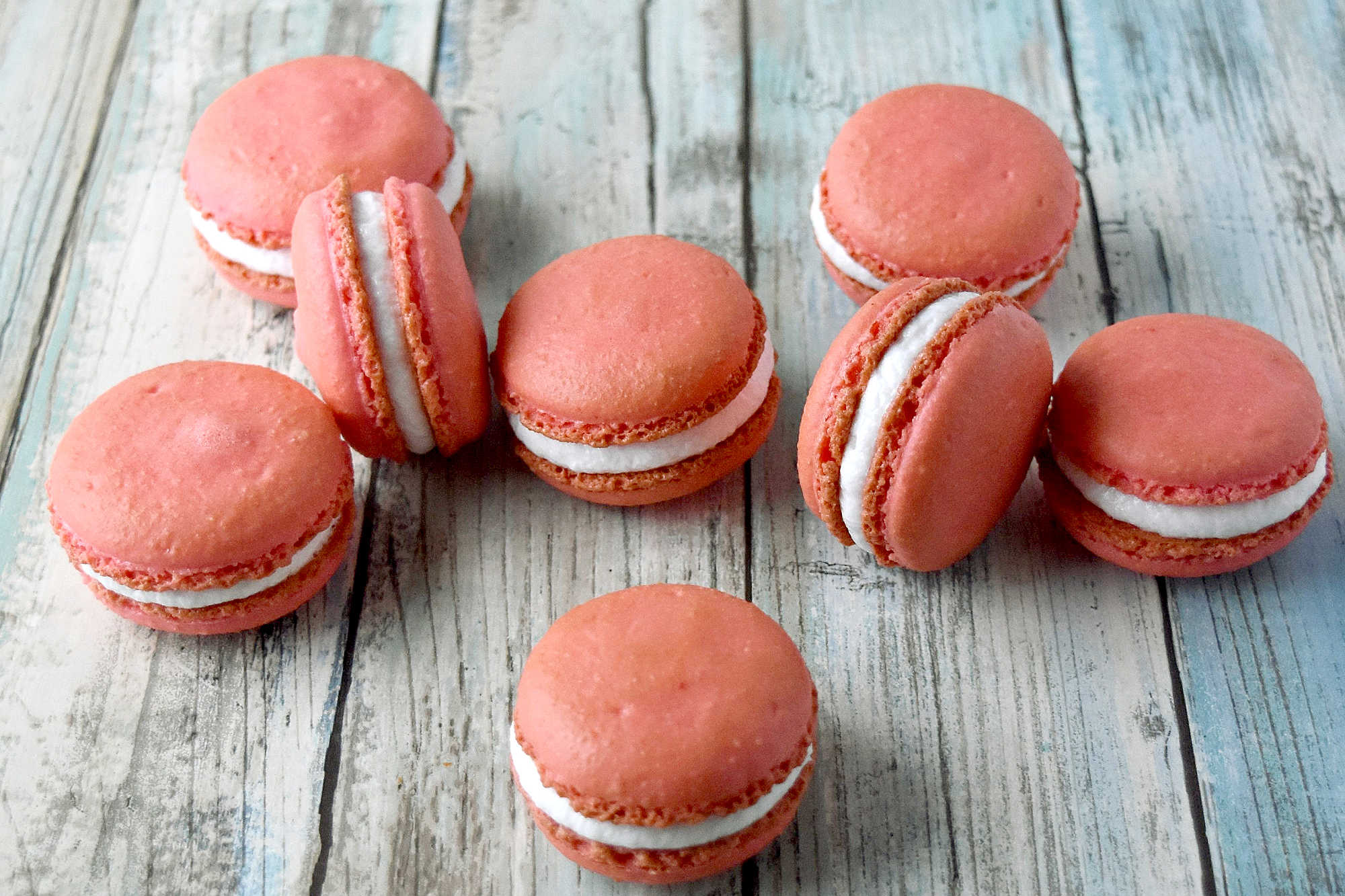 Peach macarons are the sweetest little summer bake. These use freeze-dried peaches in the shells and peach syrup in the filling for bright, fruity flavor in every bite. Perfect for a beginner-friendly showstopper! #peachmacarons #macarons #frenchmacarons #macaronlove #peachdessert #summerdesserts #prettybakes #bakingfromscratch #homebaker #desserttable #teapartyideas #bridalshowerdesserts #Stonefruit