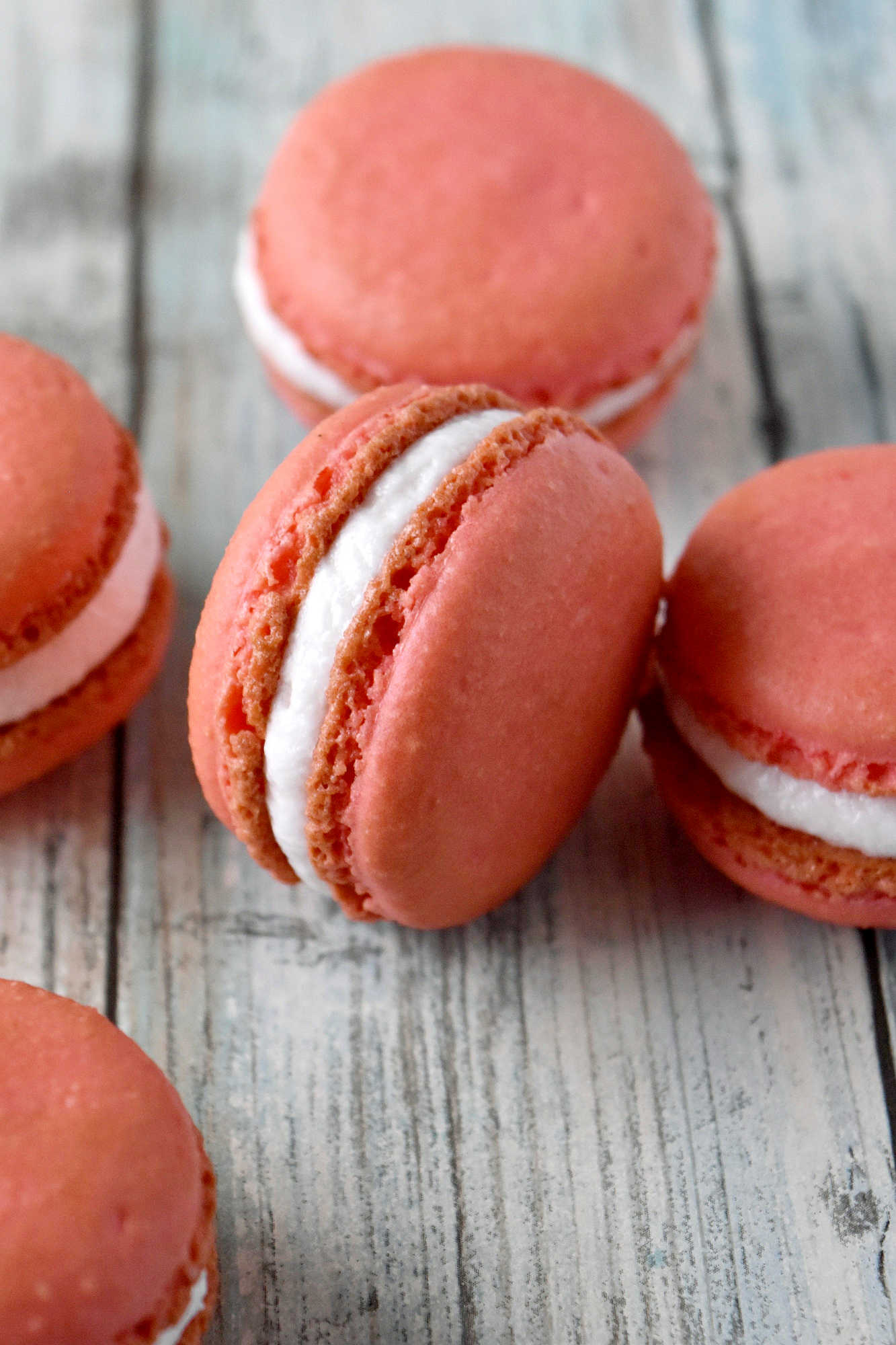 Peach macarons are the sweetest little summer bake. These use freeze-dried peaches in the shells and peach syrup in the filling for bright, fruity flavor in every bite. Perfect for a beginner-friendly showstopper! #peachmacarons #macarons #frenchmacarons #macaronlove #peachdessert #summerdesserts #prettybakes #bakingfromscratch #homebaker #desserttable #teapartyideas #bridalshowerdesserts #Stonefruit