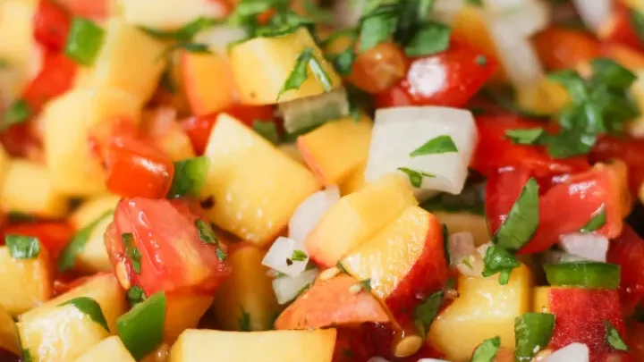 Make this fresh Pioneer Woman Peach Salsa with juicy peaches, tomatoes, jalapeños, cilantro, and lime. A sweet and spicy salsa perfect for chips, tacos, grilled chicken, and summer cookouts.