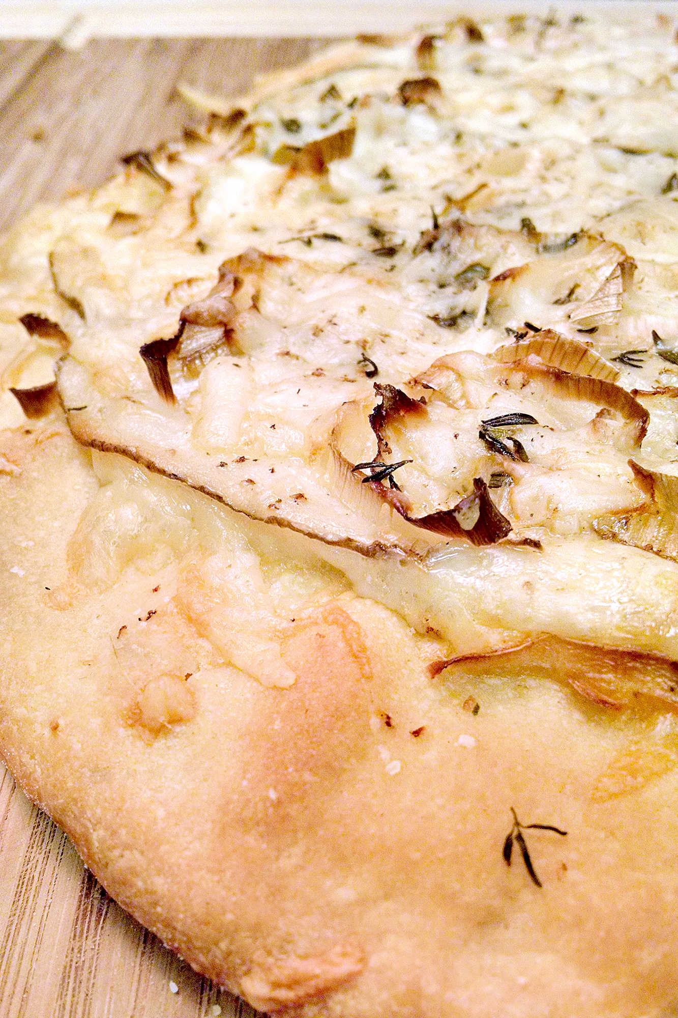 This rustic potato leek pizza uses thinly sliced russet potatoes, sweet leeks, garlic, mozzarella, and asiago on a store‑bought crust. A cozy homemade pizza perfect for easy weeknight dinners, National Potato Day, or anyone craving a unique potato pizza recipe with simple ingredients. #pizza #leek #potatoleekrecipe #pizzarecipe #meatless #potatoleekpizza #homemadepizza #pizzaloversunite #vegetarianeats #foodfromthegarden #MashupRecipe #PizzaRevolution