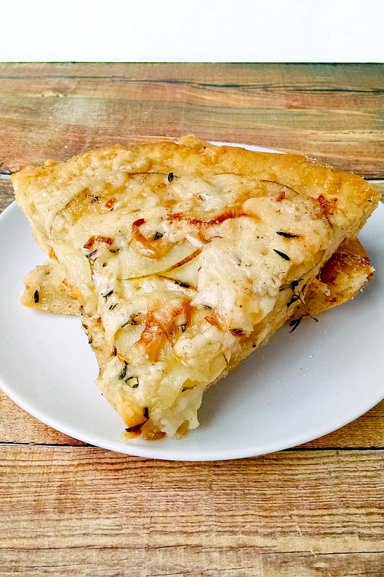 This rustic potato leek pizza uses thinly sliced russet potatoes, sweet leeks, garlic, mozzarella, and asiago on a store‑bought crust. A cozy homemade pizza perfect for easy weeknight dinners, National Potato Day, or anyone craving a unique potato pizza recipe with simple ingredients. #pizza #leek #potatoleekrecipe #pizzarecipe #meatless #potatoleekpizza #homemadepizza #pizzaloversunite #vegetarianeats #foodfromthegarden #MashupRecipe #PizzaRevolution