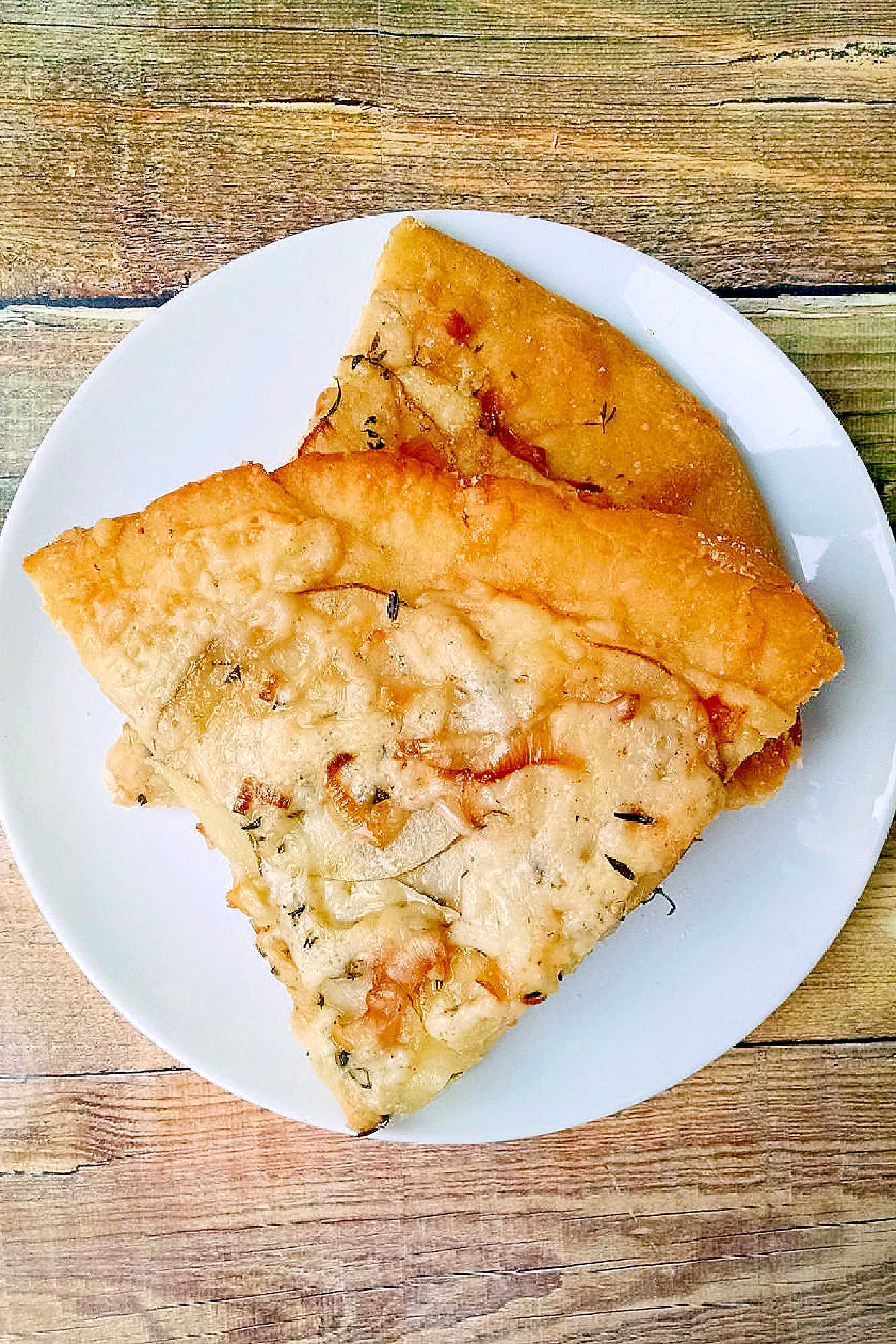 This rustic potato leek pizza uses thinly sliced russet potatoes, sweet leeks, garlic, mozzarella, and asiago on a store‑bought crust. A cozy homemade pizza perfect for easy weeknight dinners, National Potato Day, or anyone craving a unique potato pizza recipe with simple ingredients. #pizza #leek #potatoleekrecipe #pizzarecipe #meatless #potatoleekpizza #homemadepizza #pizzaloversunite #vegetarianeats #foodfromthegarden #MashupRecipe #PizzaRevolution
