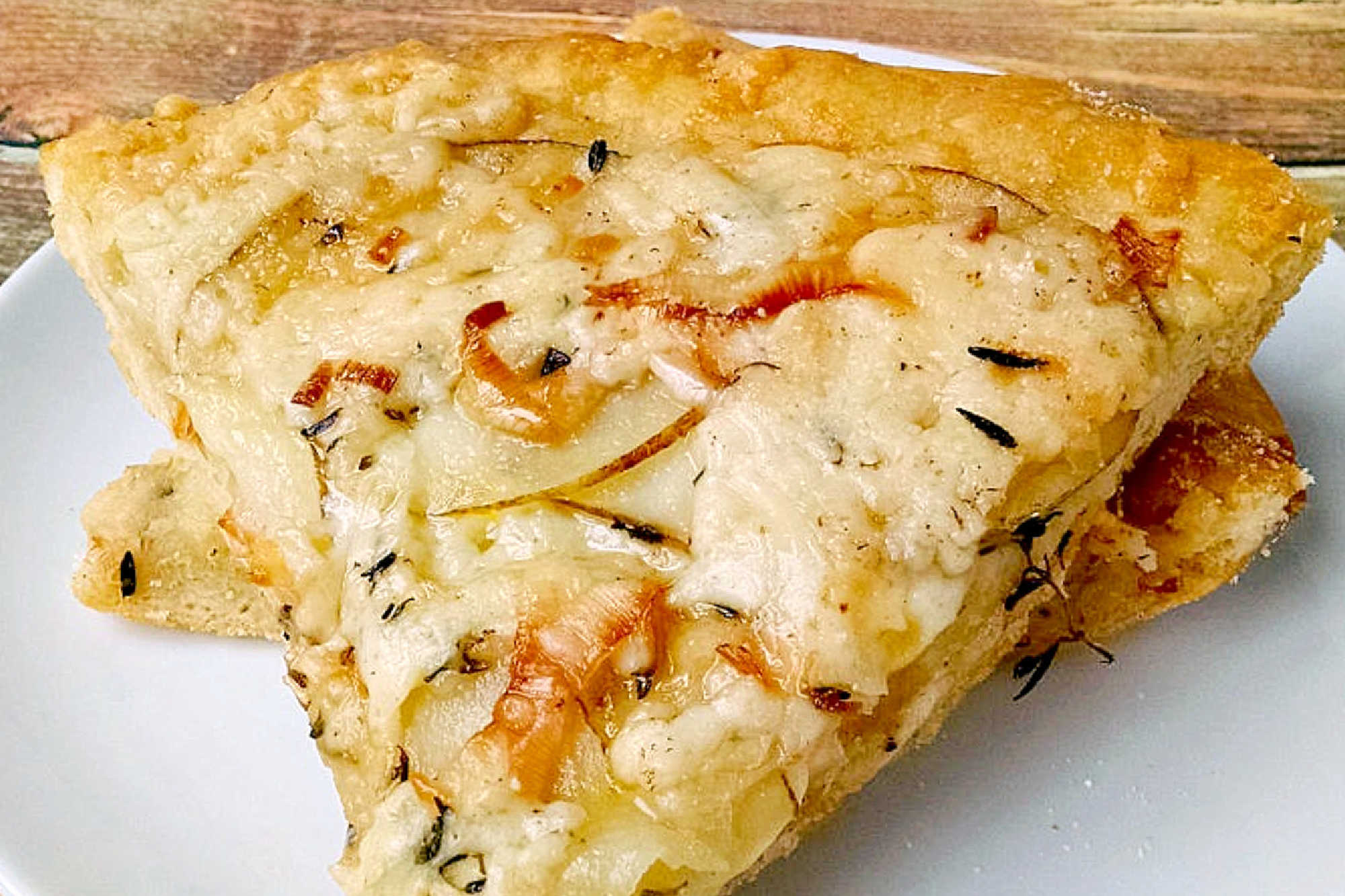 This rustic potato leek pizza uses thinly sliced russet potatoes, sweet leeks, garlic, mozzarella, and asiago on a store‑bought crust. A cozy homemade pizza perfect for easy weeknight dinners, National Potato Day, or anyone craving a unique potato pizza recipe with simple ingredients. #pizza #leek #potatoleekrecipe #pizzarecipe #meatless #potatoleekpizza #homemadepizza #pizzaloversunite #vegetarianeats #foodfromthegarden #MashupRecipe #PizzaRevolution