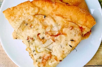 This rustic potato leek pizza uses thinly sliced russet potatoes, sweet leeks, garlic, mozzarella, and asiago on a store‑bought crust. A cozy homemade pizza perfect for easy weeknight dinners, National Potato Day, or anyone craving a unique potato pizza recipe with simple ingredients. #pizza #leek #potatoleekrecipe #pizzarecipe #meatless #potatoleekpizza #homemadepizza #pizzaloversunite #vegetarianeats #foodfromthegarden #MashupRecipe #PizzaRevolution