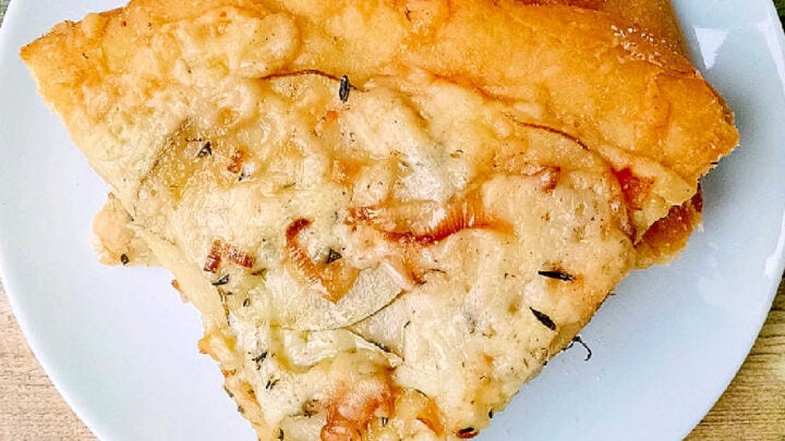 This rustic potato leek pizza uses thinly sliced russet potatoes, sweet leeks, garlic, mozzarella, and asiago on a store‑bought crust. A cozy homemade pizza perfect for easy weeknight dinners, National Potato Day, or anyone craving a unique potato pizza recipe with simple ingredients. #pizza #leek #potatoleekrecipe #pizzarecipe #meatless #potatoleekpizza #homemadepizza #pizzaloversunite #vegetarianeats #foodfromthegarden #MashupRecipe #PizzaRevolution