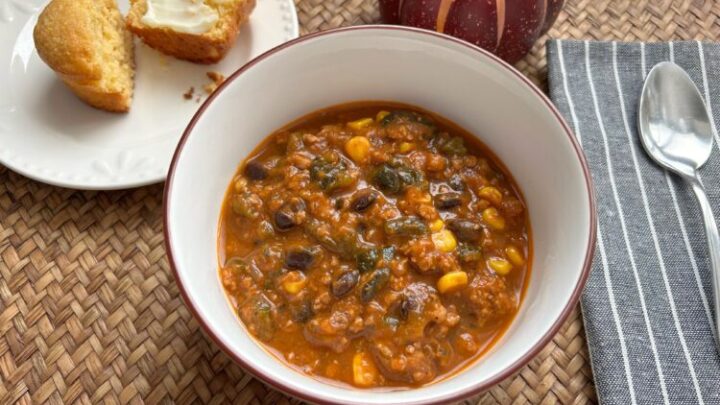 This hearty fall chili combines creamy pumpkin, smoky roasted poblanos, black beans, sweet corn, and savory spices for a delicious twist on old-fashioned chili.