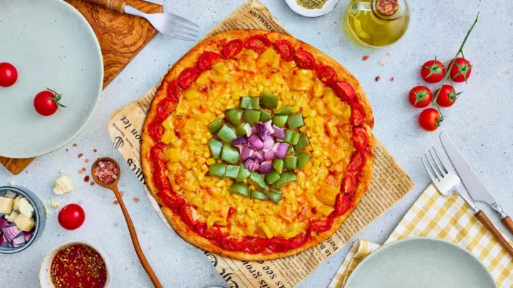 Make this easy Rainbow Veggie Pizza with colorful tomatoes, peppers, corn, and onion. It’s a fun, family-friendly recipe kids can help make.
