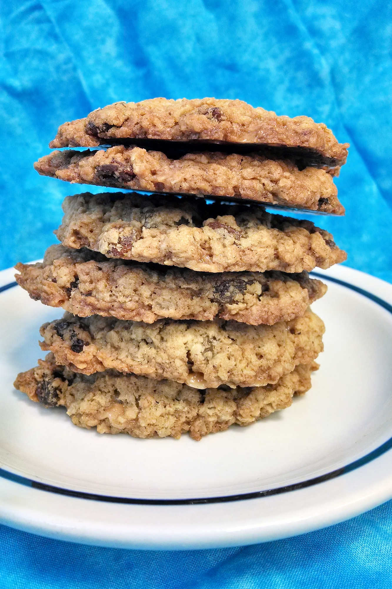 Classic oatmeal raisin cookies meet buttery candy-shop crunch in this chewy toffee cookie recipe. These Oatmeal Raisin Toffe Cookies are cozy enough for fall baking and fun enough for a cookie tray.  #OatmealCookies #RaisinCookies #ToffeeCookies #CookieRecipe #HolidayBaking #OurFamilyTable
