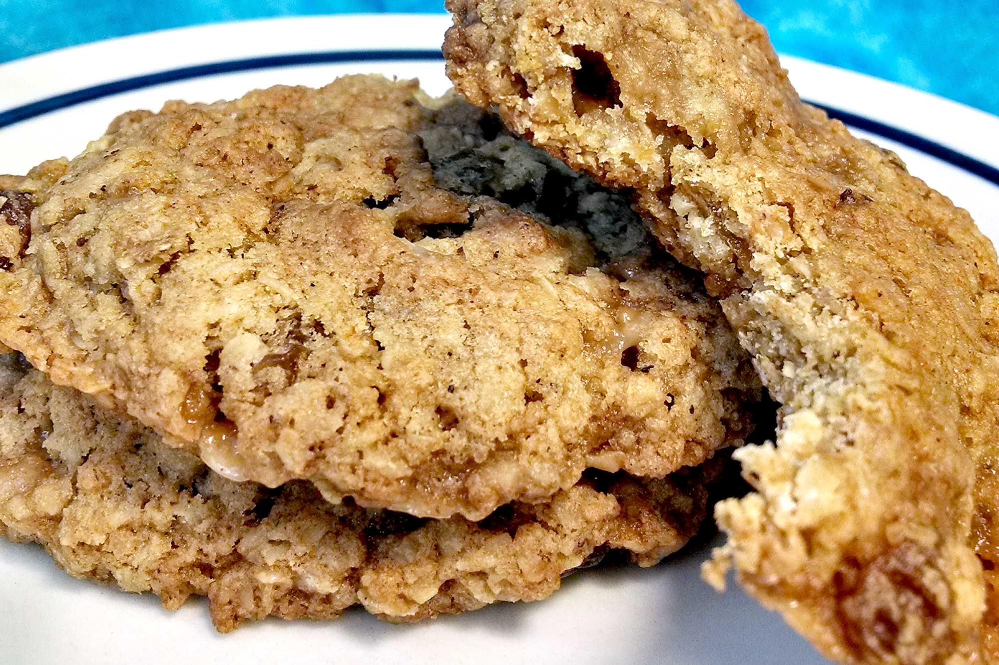 Classic oatmeal raisin cookies meet buttery candy-shop crunch in this chewy toffee cookie recipe. These Oatmeal Raisin Toffe Cookies are cozy enough for fall baking and fun enough for a cookie tray.  #OatmealCookies #RaisinCookies #ToffeeCookies #CookieRecipe #HolidayBaking #OurFamilyTable